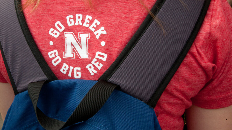 Back of Go Greek t-shirt worn by student
