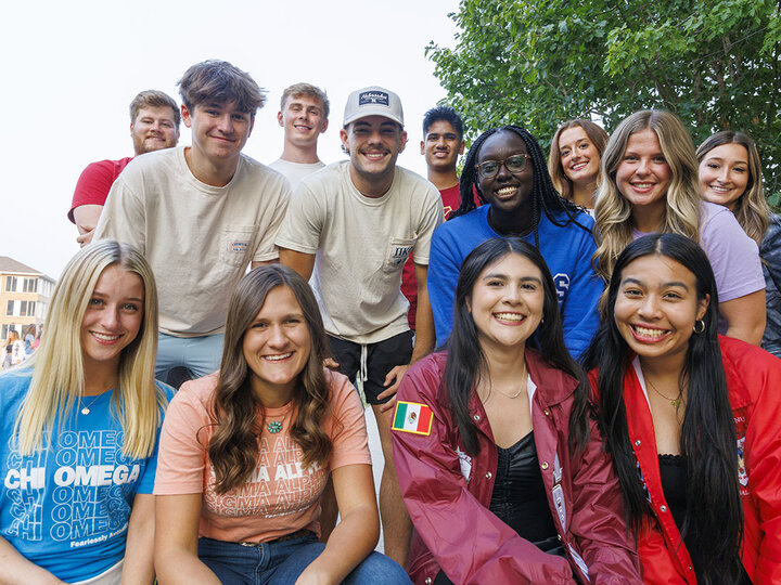 Thirteen sorority and fraternity members pose in a group photo. September 2023.